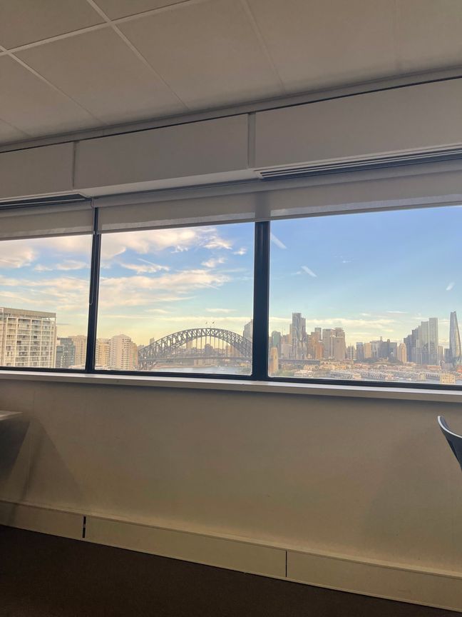 Window view of Sydney’s harbour, with the Harbour Bridge in sight.