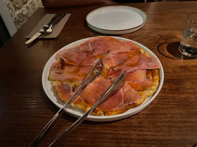 Photo of an Italian entree with cheese and prosciutto